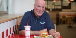 Jerry Murrell, founder of Five Guys, poses for a photograph inside the company's new hamburger outlet in London, U.K., on Tuesday, July 2, 2013.